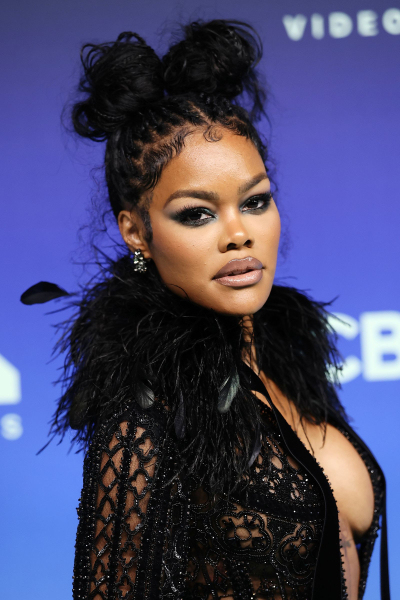 Teyana Taylor in a black beaded and feathered dress